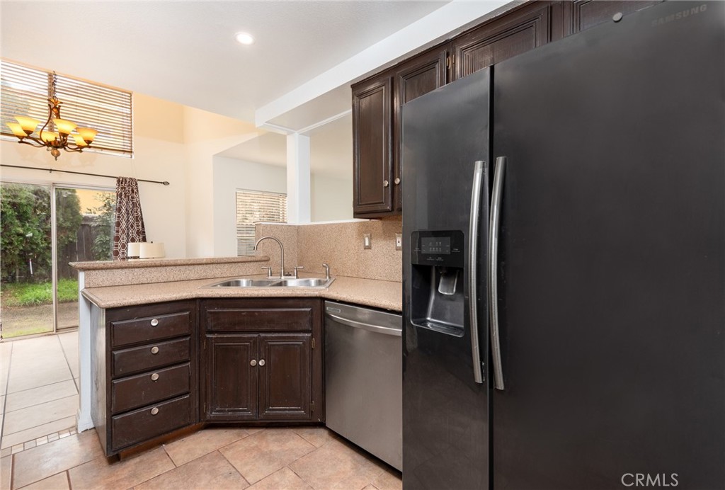 12306 Clover Road Pacoima, CA 91331 - Photo 8 of 18 a kitchen with a refrigerator and a sink