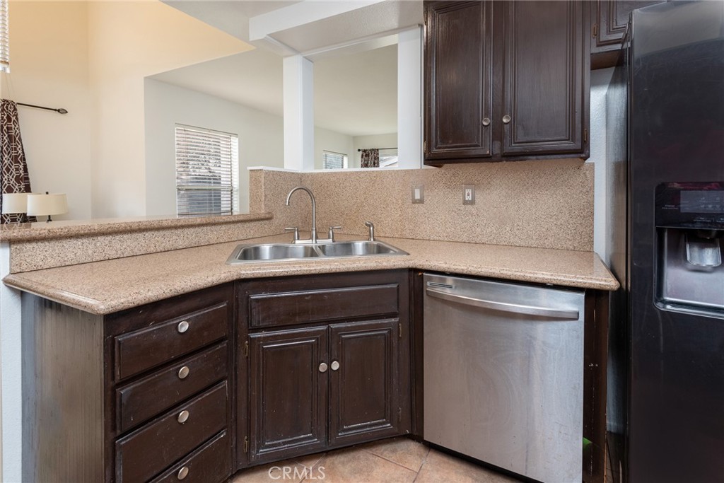 12306 Clover Road Pacoima, CA 91331 - Photo 9 of 18 a kitchen with a sink and a refrigerator
