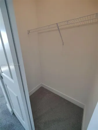 a white toilet sitting next to a white sink