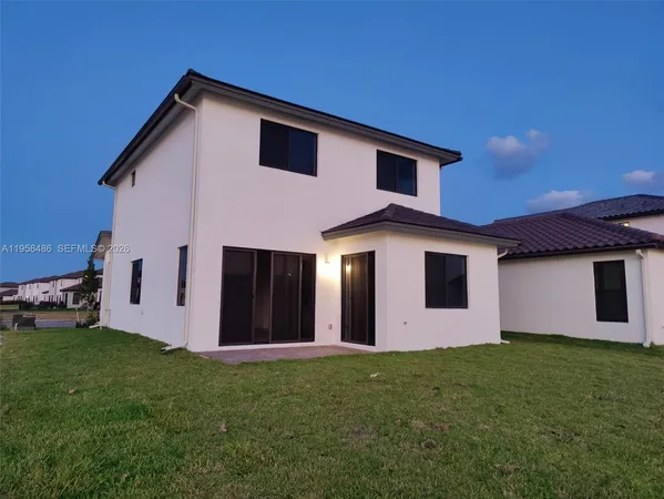 a front view of house with yard and garage