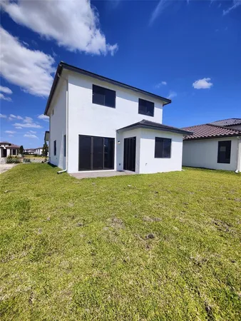 a view of a house with a backyard