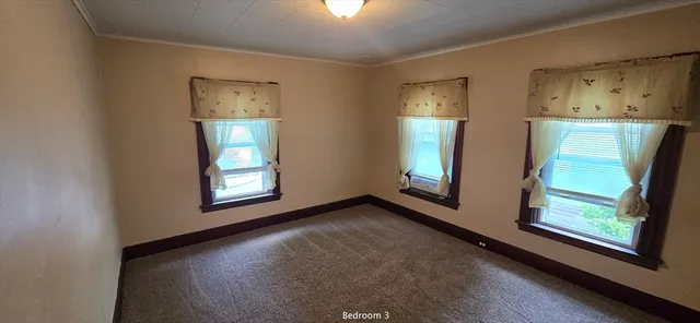 a dining hall with stainless steel appliances kitchen island granite countertop a dining table and chairs with wooden floor