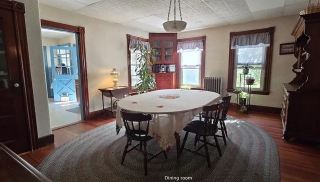 a view of a dining room with furniture window and wooden floor
