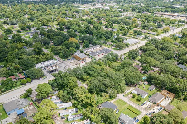 an aerial view of residential house with outdoor space and trees all around