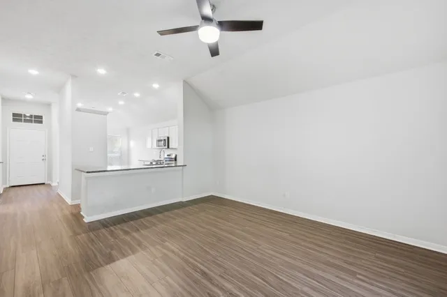 a view of a room with wooden floor