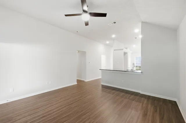 a bathroom with a granite countertop bathtub a sink and a large mirror