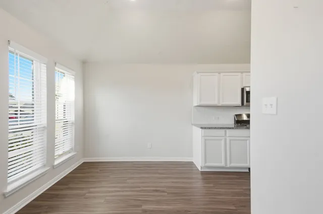 a kitchen with a sink stove and microwave