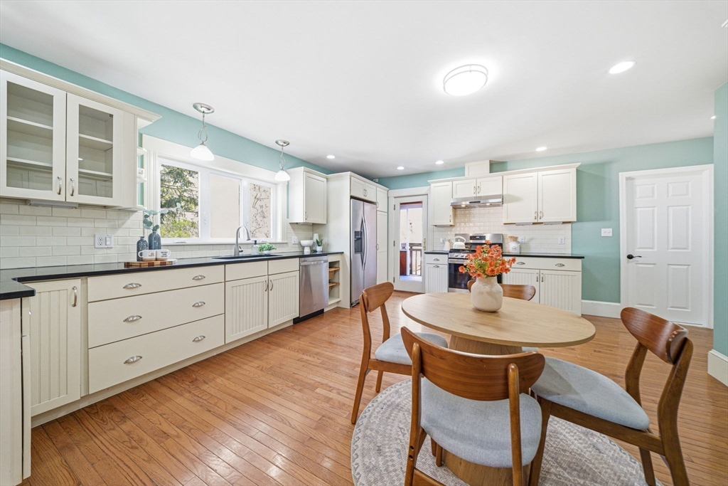 45 Marion Street Natick, MA 01760 - Photo 17 of 42 a kitchen with a dining table chairs and white cabinets