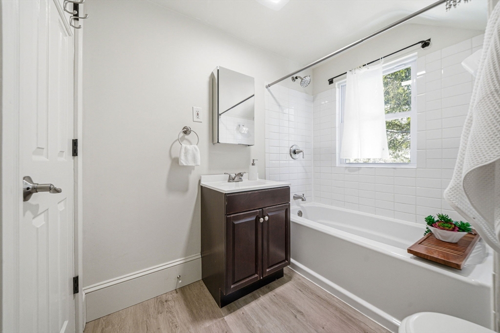 45 Marion Street Natick, MA 01760 - Photo 28 of 42 a bathroom with a tub shower sink and vanity