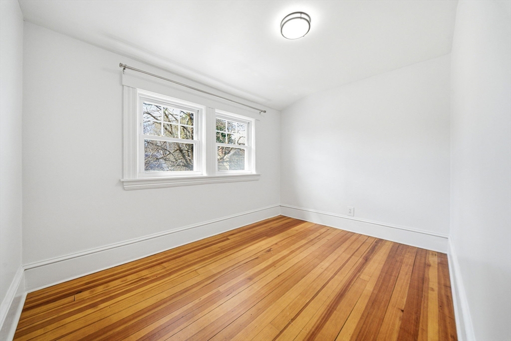 45 Marion Street Natick, MA 01760 - Photo 31 of 42 an empty room with wooden floor and windows