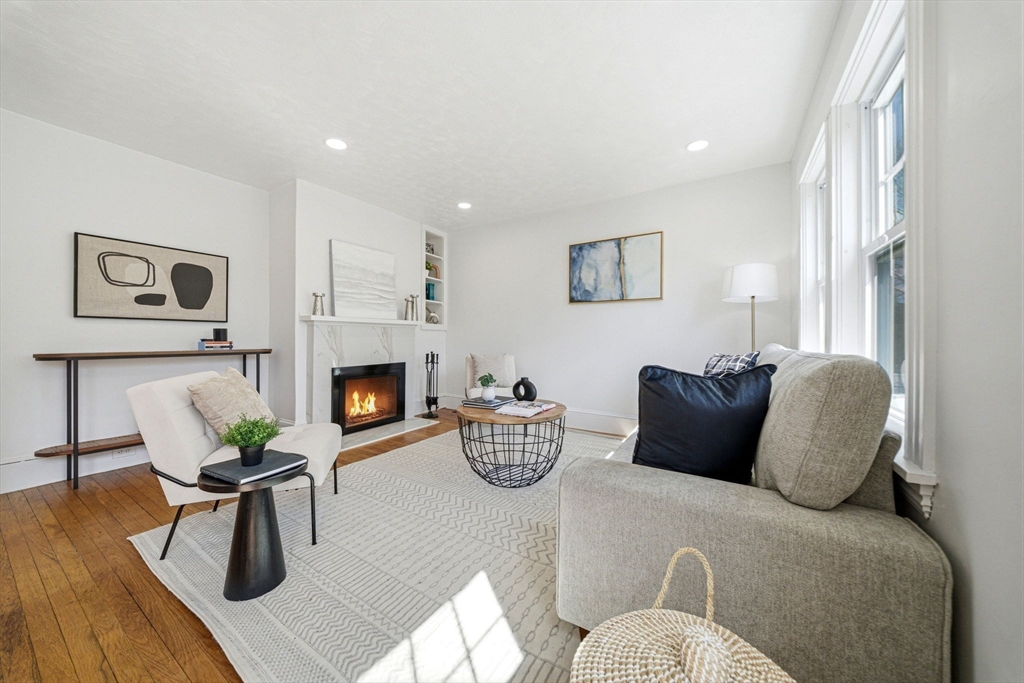 45 Marion Street Natick, MA 01760 - Photo 8 of 42 a living room with furniture and a fireplace