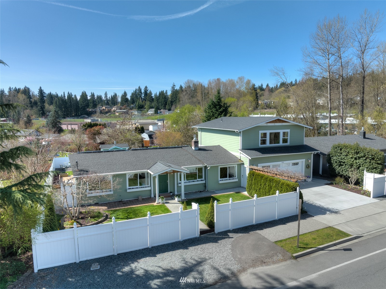 24204 Lockwood Road Bothell, WA 98021 - Photo 1 of 40 a front view of a house with a large pool and a yard