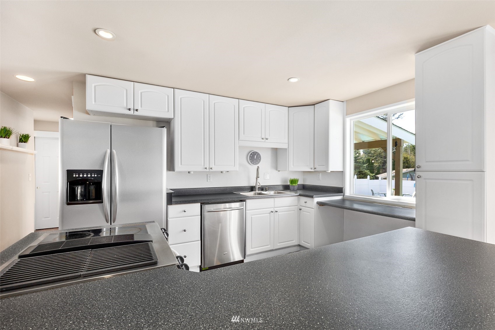 24204 Lockwood Road Bothell, WA 98021 - Photo 12 of 40 a kitchen with granite countertop a stove sink and refrigerator