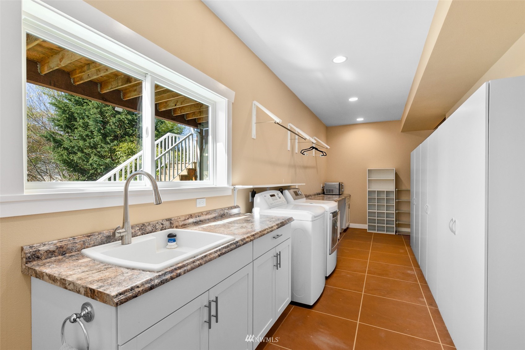24204 Lockwood Road Bothell, WA 98021 - Photo 23 of 40 a bathroom with a granite countertop sink and a large mirror
