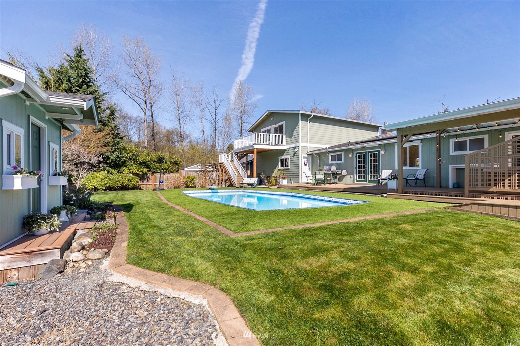24204 Lockwood Road Bothell, WA 98021 - Photo 31 of 40 a swimming pool view with a seating space and a garden view