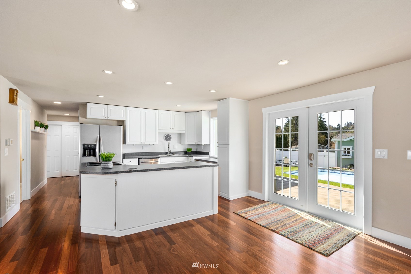 24204 Lockwood Road Bothell, WA 98021 - Photo 10 of 40 a kitchen with stainless steel appliances granite countertop a stove and a refrigerator
