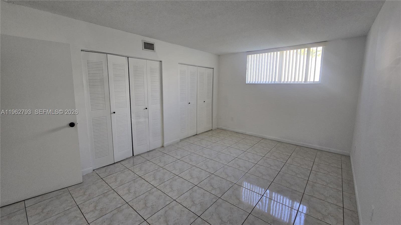 8320 Northwest 8th Street, Unit 2110 Miami, FL 33126 - Photo 12 of 13 a view of an empty room with window and closet area
