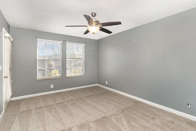 an empty room with fan and a ceiling fan
