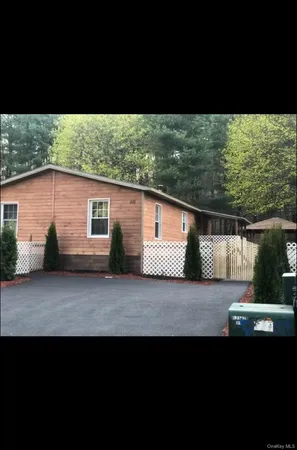 a view of a house with a backyard