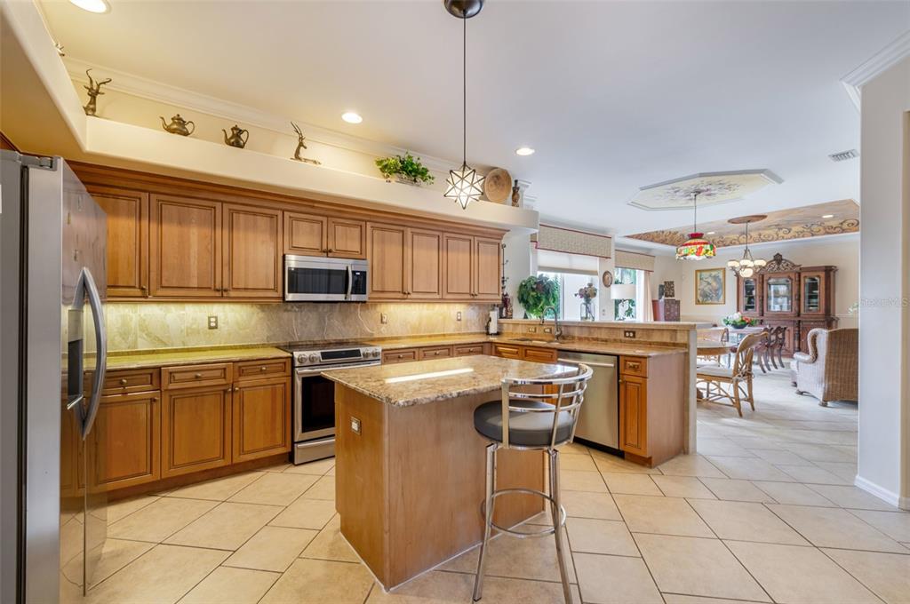 13881 Blenheim Trail Road Fort Myers, FL 33908 - Photo 16 of 82 a kitchen with cabinets and chairs