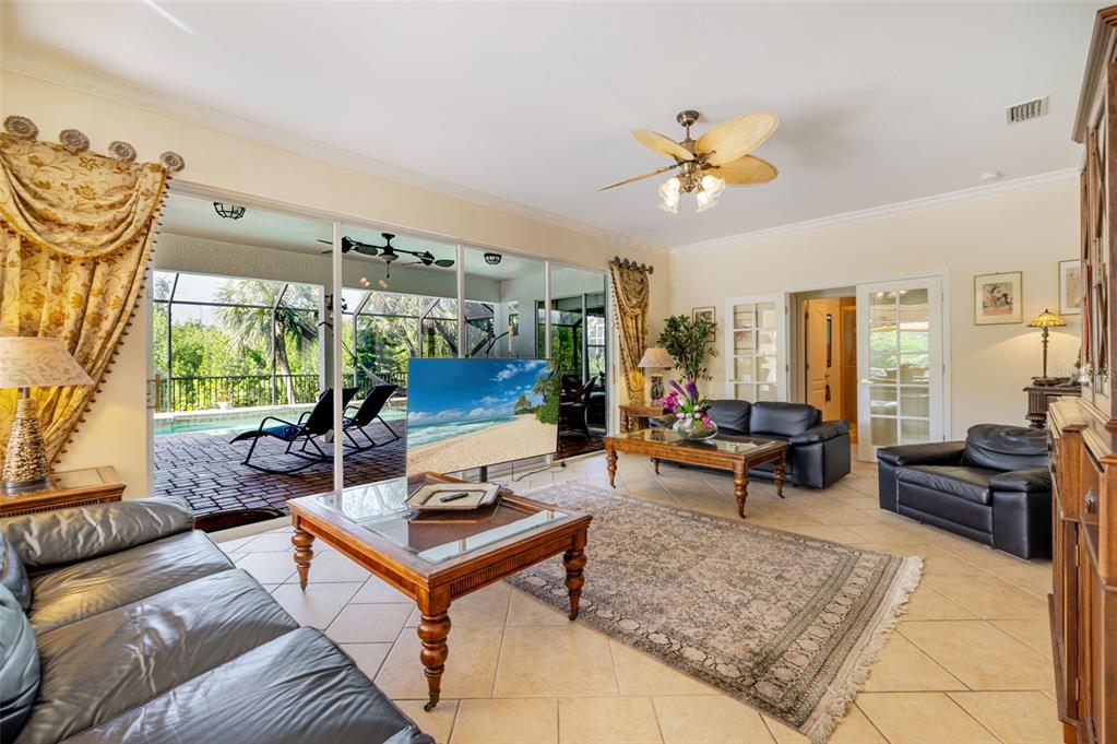 13881 Blenheim Trail Road Fort Myers, FL 33908 - Photo 20 of 82 a living room with furniture a table and a large window