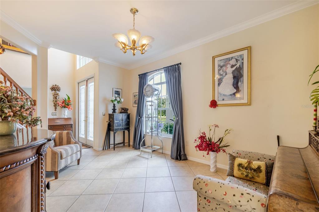 13881 Blenheim Trail Road Fort Myers, FL 33908 - Photo 27 of 82 a living room with furniture and a chandelier