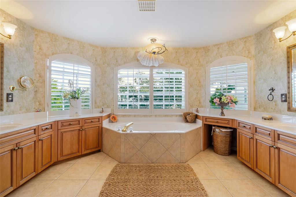 13881 Blenheim Trail Road Fort Myers, FL 33908 - Photo 37 of 82 a large spacious bathroom with a large tub a sink and large window