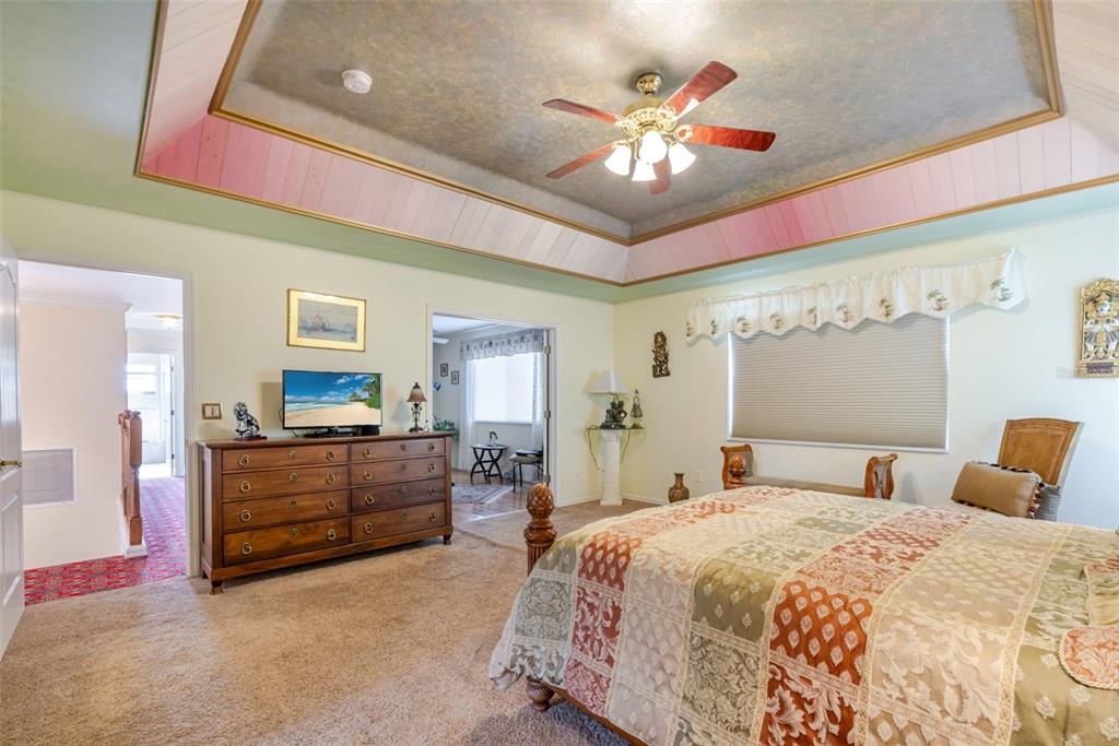 13881 Blenheim Trail Road Fort Myers, FL 33908 - Photo 40 of 82 a bedroom with a bed and a chandelier