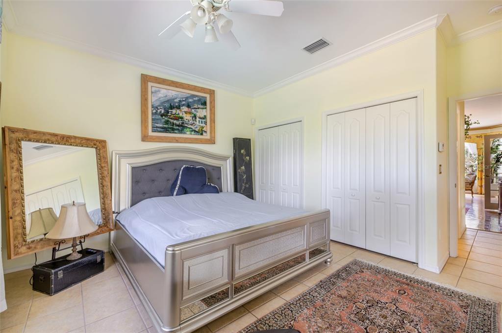 13881 Blenheim Trail Road Fort Myers, FL 33908 - Photo 44 of 82 a spacious bedroom with a bed and a mirror