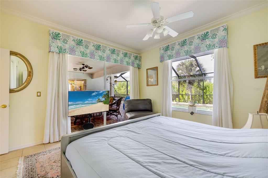 13881 Blenheim Trail Road Fort Myers, FL 33908 - Photo 45 of 82 a bedroom with a bed a window and a chandelier
