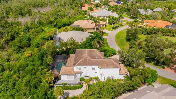 a kitchen with stainless steel appliances granite countertop a refrigerator a sink dishwasher a stove and white cabinets with wooden floor