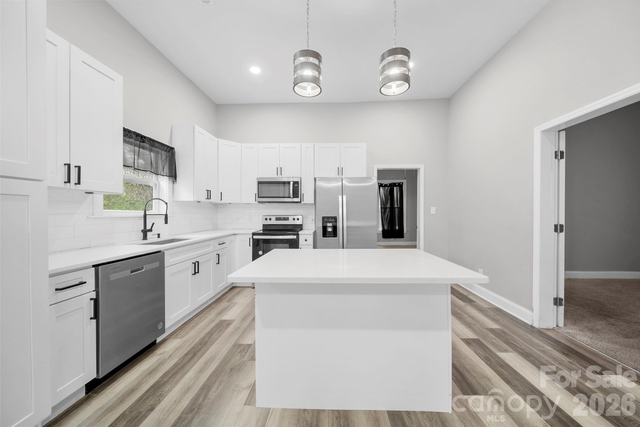136 East Lacy Street Chester, SC 29706 - Photo 11 of 18 a kitchen with stainless steel appliances a refrigerator sink and cabinets