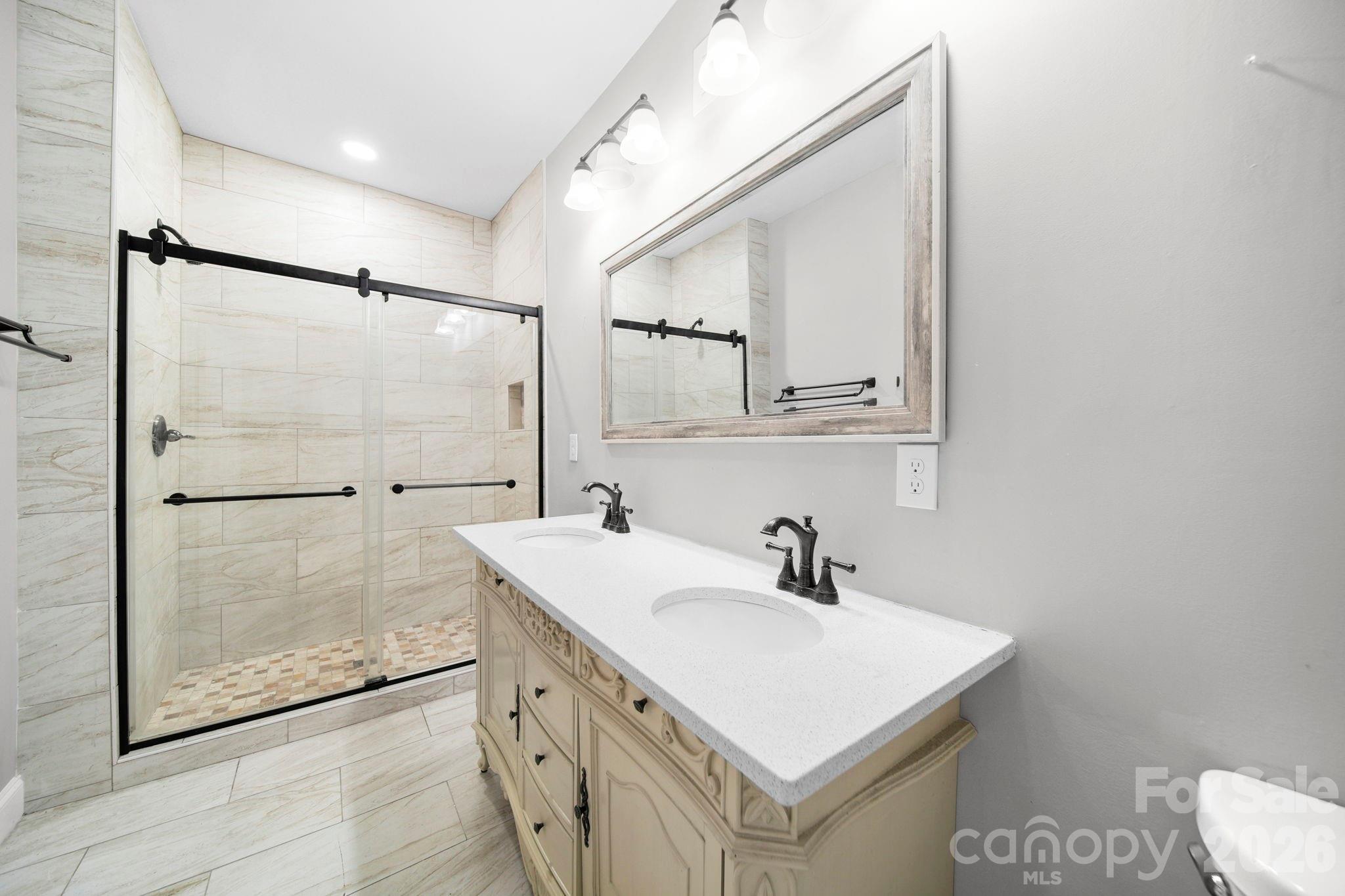 136 East Lacy Street Chester, SC 29706 - Photo 16 of 18 a bathroom with a sink mirror and a shower