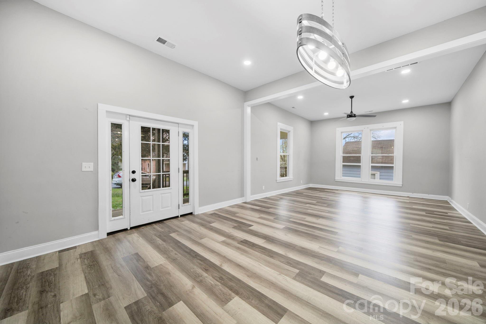 136 East Lacy Street Chester, SC 29706 - Photo 6 of 18 a view of an empty room with wooden floor and a window