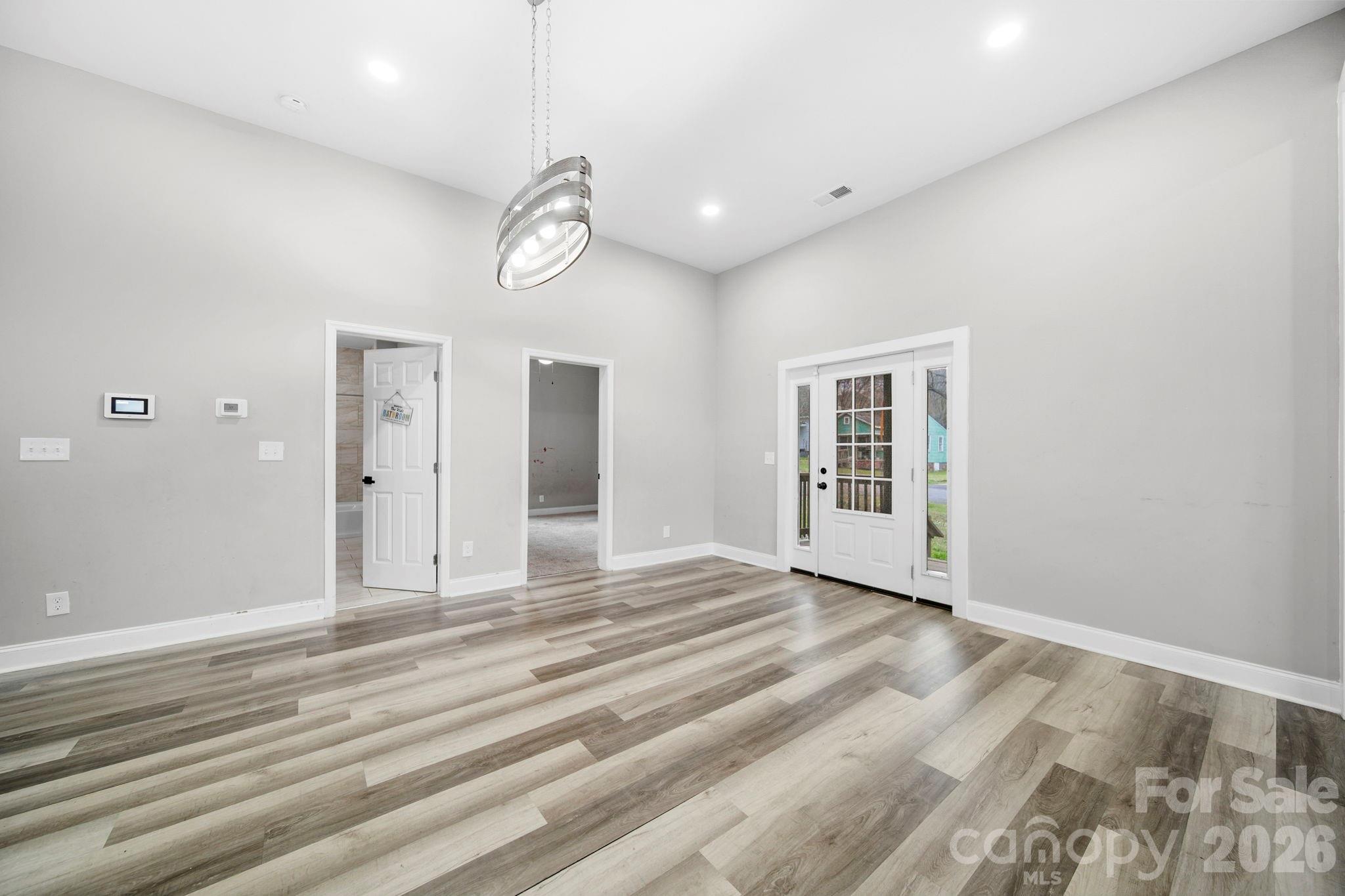 136 East Lacy Street Chester, SC 29706 - Photo 9 of 18 a view of an empty room with wooden floor and windows