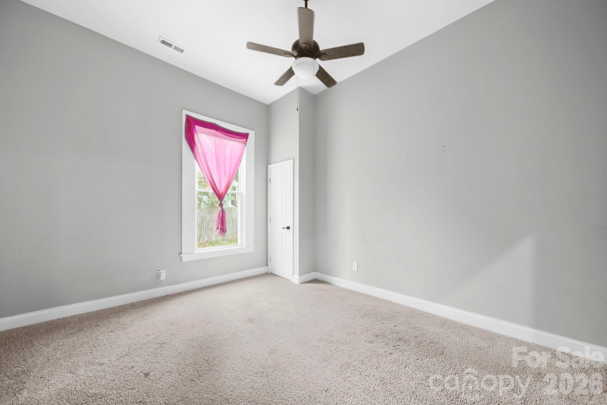 136 East Lacy Street Chester, SC 29706 - Photo 10 of 18 an empty room with windows and fan