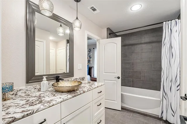 a bathroom with a tub sink and mirror