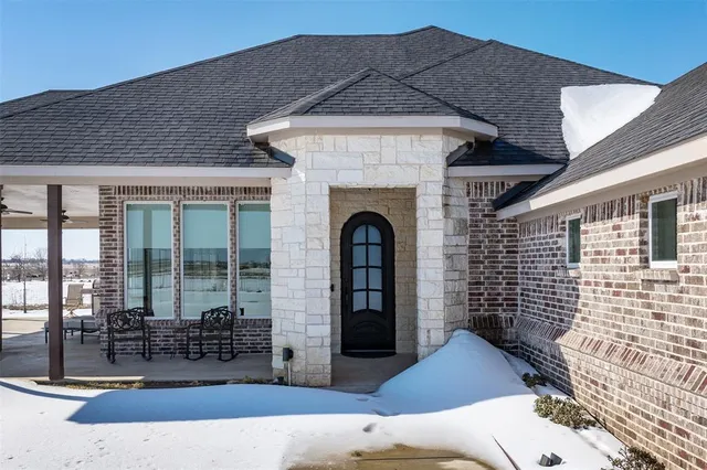 a front view of a house with outdoor seating
