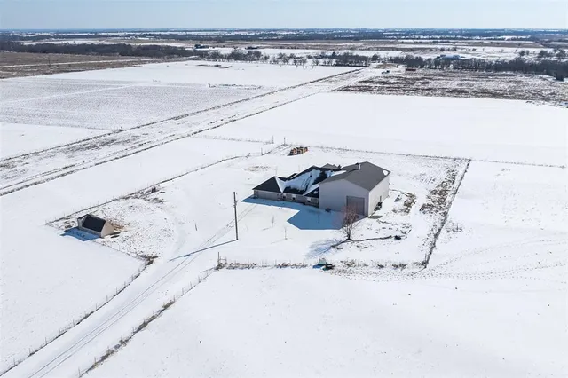 a view of a balcony with wooden floor next to a ocean