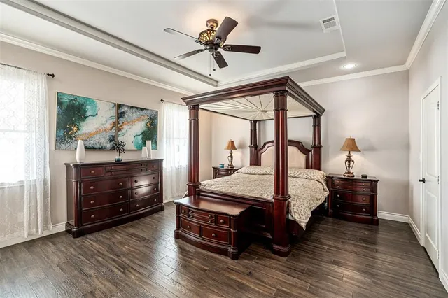 a bedroom with a bed window and a ceiling fan