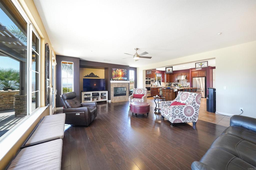 22963 Stokes Road Ramona, CA 92065 - Photo 22 of 57 a living room with furniture and a flat screen tv