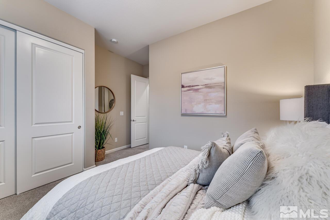 9915 Hafflinger Lane Reno, NV 89521 - Photo 29 of 40 a bedroom with a bed and painting on the wall