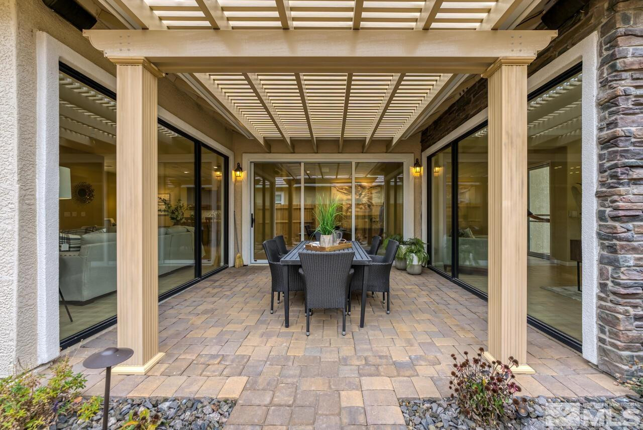 9915 Hafflinger Lane Reno, NV 89521 - Photo 35 of 40 a view of a patio with table and chairs potted plants