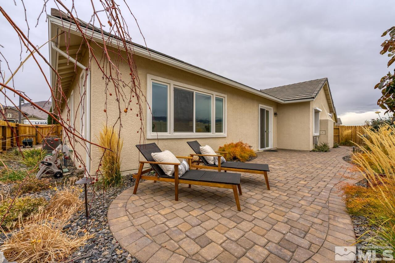 9915 Hafflinger Lane Reno, NV 89521 - Photo 38 of 40 a backyard of a house with wooden chairs and wooden fence