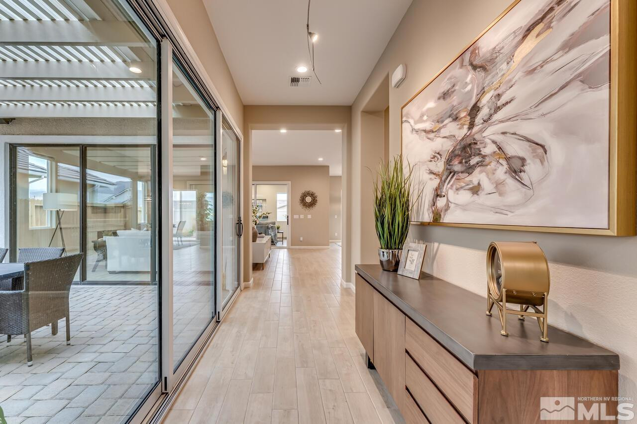 9915 Hafflinger Lane Reno, NV 89521 - Photo 7 of 40 a view of a hallway to a livingroom with furniture