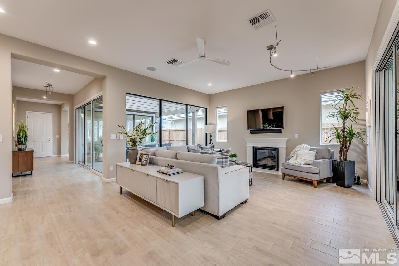 9915 Hafflinger Lane Reno, NV 89521 - Photo 10 of 40 a living room with furniture and a flat screen tv