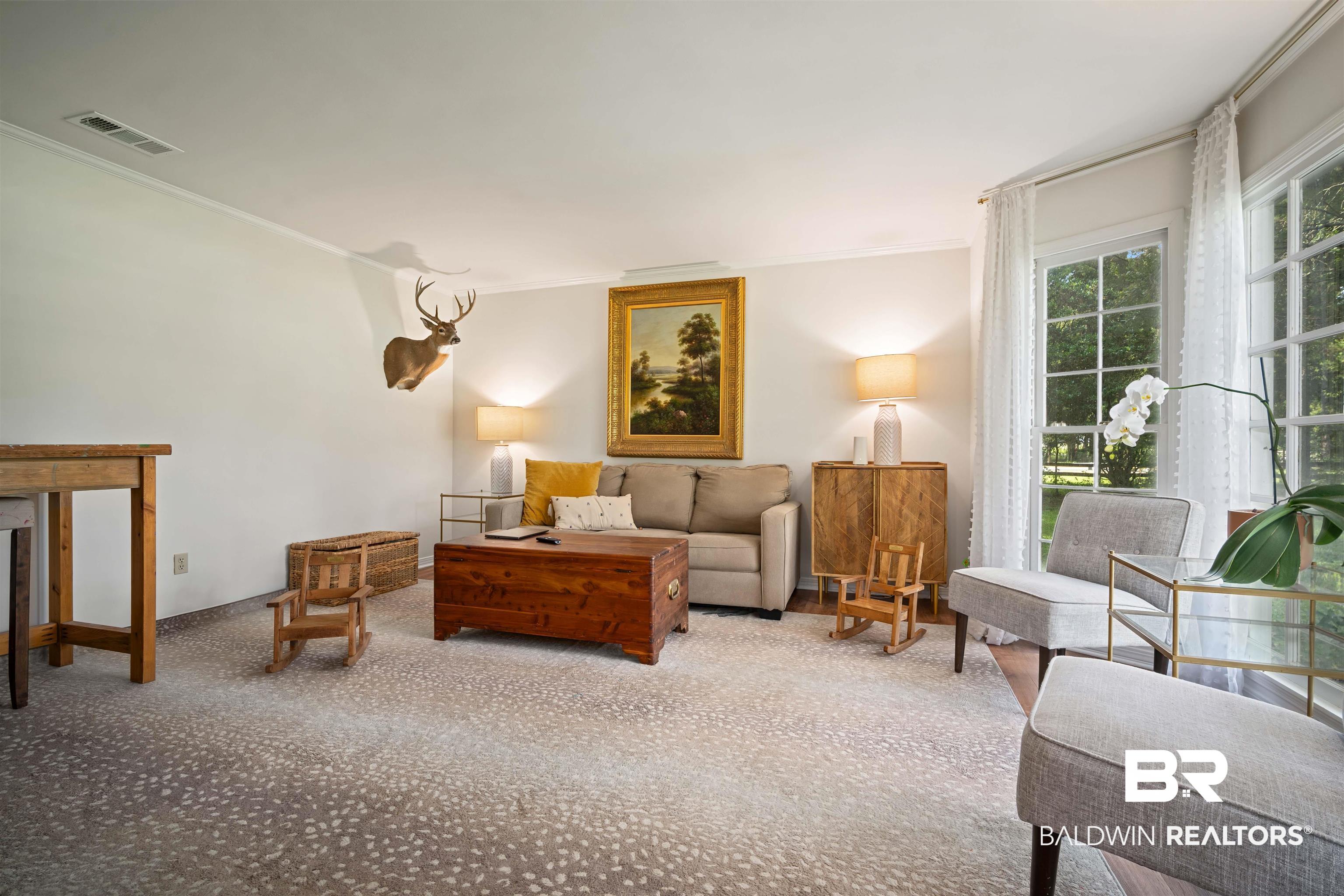 700 Eliza Jordan Road North Mobile, AL 36608 - Photo 11 of 44 Living room with crown molding and carpet