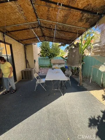 a patio with a table and chairs