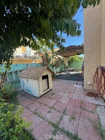 a view of backyard with outdoor seating and green space