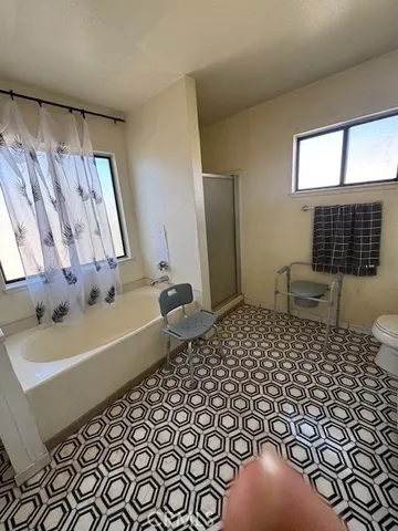 a bathroom with a sink toilet and window